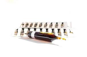 Group of ampoules with a transparent medicine in medical laboratory. lot of ampoules on light background. photo