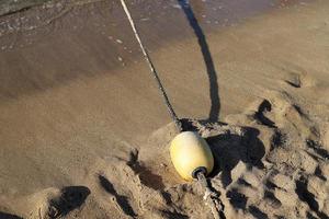 Hemp rope with buoys on the city beach photo