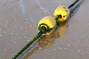 Hemp rope with buoys on the city beach photo