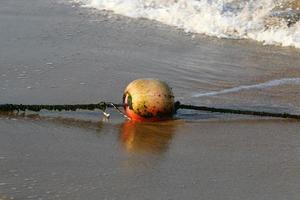 Hemp rope with buoys on the city beach photo