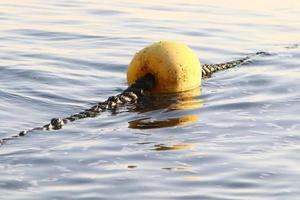 Hemp rope with buoys on the city beach photo