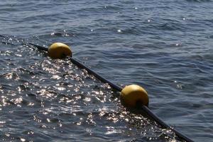 Hemp rope with buoys on the city beach photo