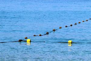 Hemp rope with buoys on the city beach photo