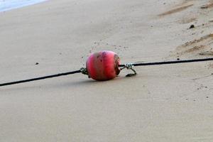 Hemp rope with buoys on the city beach photo