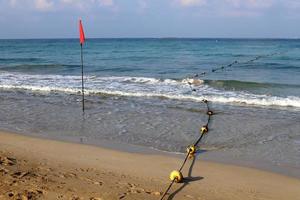 Hemp rope with buoys on the city beach photo