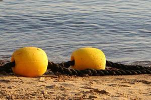 Hemp rope with buoys on the city beach photo