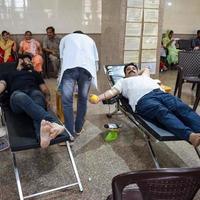 Delhi, India, June 19 2022 - Blood donor at Blood donation camp held at Balaji Temple, Vivek Vihar, Delhi, India, Image for World blood donor day on June 14 every year, Blood Donation Camp at Temple photo