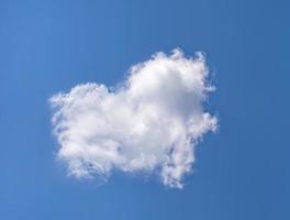 Blue sky with white clouds, love theme background. Clear blue sky with heart-shaped clouds with space for text photo