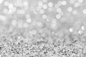 New year and Christmas. Top view of silver Glitter and white confetti lights bokeh get out of focus. abstract background photo