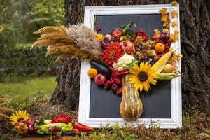 bodegón con verduras, frutas, un girasol y mazorcas de maíz. foto de la naturaleza