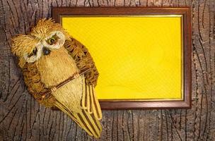 Owl. Frame with yellow background in frame with web for text. Tree bark background. Back to school. Autumn. Copy space photo