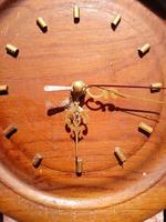 Analog wall clock made of wood has an old or vintage feel photo