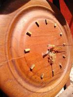 Analog wall clock made of wood has an old or vintage feel photo