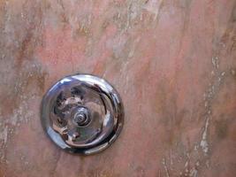 Silver round object on marble background photo