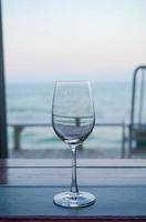 empty wine glass with sea background photo