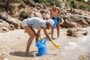 Mother And Daughter Cleaning Up The Beach photo