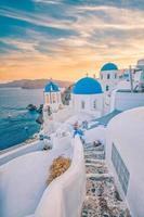 fantástica isla mediterránea de santorini, grecia. increíble amanecer romántico en el fondo de oia, luz de la mañana. increíble vista del atardecer con cúpulas azules de casas blancas. paisaje de viaje panorámico. isla de los amantes foto