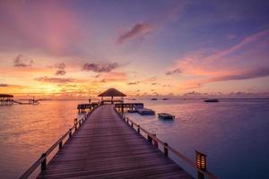 Beautiful Maldives paradise sunset. Tropical aerial landscape, seascape, water villas amazing sea sky, lagoon beach, tropical nature. Exotic tourism destination, summer aerial vacation, drone view.