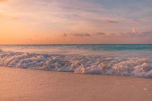 Beautiful sunrise beach. Exotic dramatic shore waves on sand, sea surface. Closeup tropical Mediterranean dream sunset sky. Peaceful tranquil relax summer colorful clouds. Positive energy meditation photo