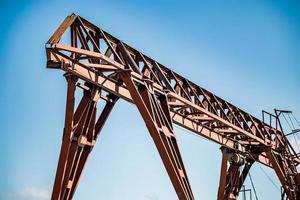 Old rusty gantry crane at abandoned construction site. photo