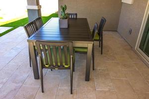 Simple Lines Of Patio Table And Chairs In Rear Yard photo