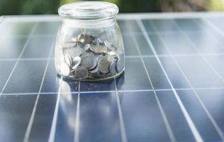 Concept of saving money if using solar energy. photo