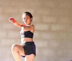 Beautiful Woman with the Red Boxing Gloves. Attractive Female Boxer Training. photo