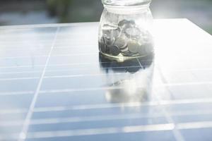 Concept of saving money if using solar energy. photo