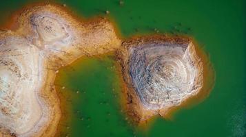 Aerial drone view of Mining activity in Minas de Riotinto in Spain. Polluted lake and water. Drought. Apocalypse scenery. Extractivism. Mining village in Andalusia. Earth destruction. Disruption. photo