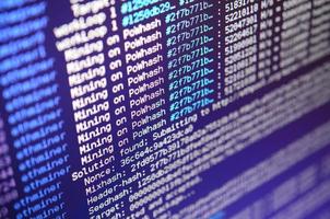 Macro snapshot of the program interface for crypto currency mining on the monitor of an office computer. The concept of mining bitcoins. The flow of information strings and data photo
