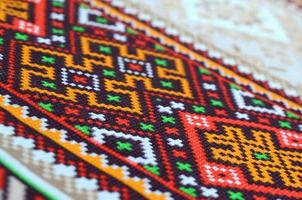 Traditional Ukrainian folk art knitted embroidery pattern on textile fabric photo