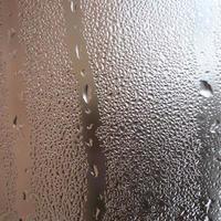 The texture of a misted glass with a lot of drops and condensation flows. Background image photo