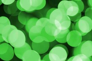 Green abstract Christmas blurred luminous background. Defocused artistic bokeh lights image photo