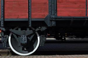 The side of the old brown wooden freight car with the wheel of the times of the Soviet Union photo