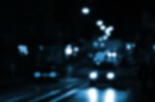 Blurred night scene of traffic on the roadway. Defocused image of cars traveling with luminous headlights. Bokeh Art photo