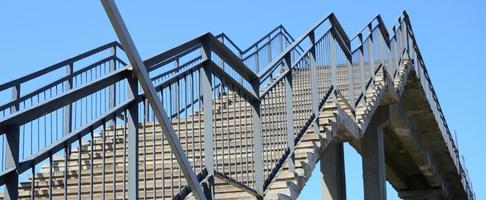 A fragment of a stepped ascent to the pedestrian bridge between the platforms of the railway station photo