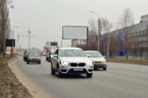 Blurred landscape with a city road during traffic photo