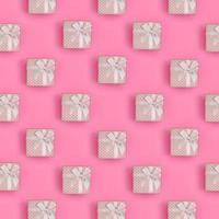 A lot of pink gift boxes lies on texture background of fashion pastel pink color paper in minimal concept. Abstract trendy pattern photo