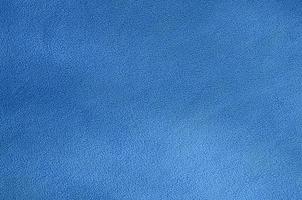 The blanket of furry blue fleece fabric. A background texture of light blue soft plush fleece material photo