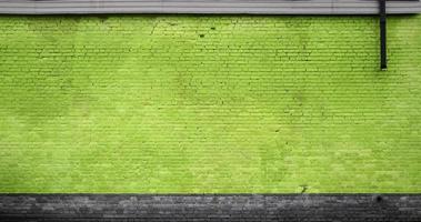 The texture of the brick wall of many rows of bricks painted in yellow color photo