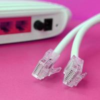 Internet router and Internet cable plugs lie on a bright pink background. Items required for Internet photo