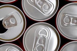 Many cans of soda soft drink or energy drink containers. A lot of recycled cans made from aluminum and being prepared for re-production. photo