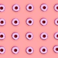 Many small plastic donuts lies on a pastel colorful background. Flat lay minimal pattern. Top view photo