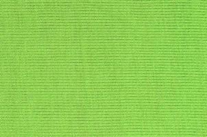 The texture of the fabric is bright green. Material for making shirts and blouses photo
