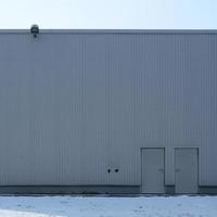 Texture of a high metal wall of an industrial building without windows photo