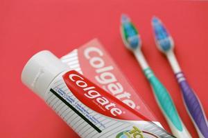 TERNOPIL, UKRAINE - JUNE 23, 2022 Colgate toothpaste and toothbrushes, a brand of oral hygiene products manufactured by American consumer-goods company Colgate-Palmolive photo