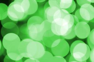 Green abstract Christmas blurred luminous background. Defocused artistic bokeh lights image photo