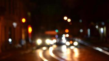 Blurred night scene of traffic on the roadway. Defocused image of cars traveling with luminous headlights. Bokeh Art photo