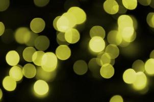 Bokeh effect golden yellow defocused light background. Christmas Lights Concept photo