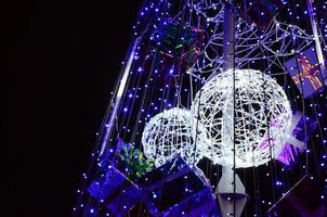 Fragment of the New Year tree. A lot of round lights of blue color are located on a conical frame photo